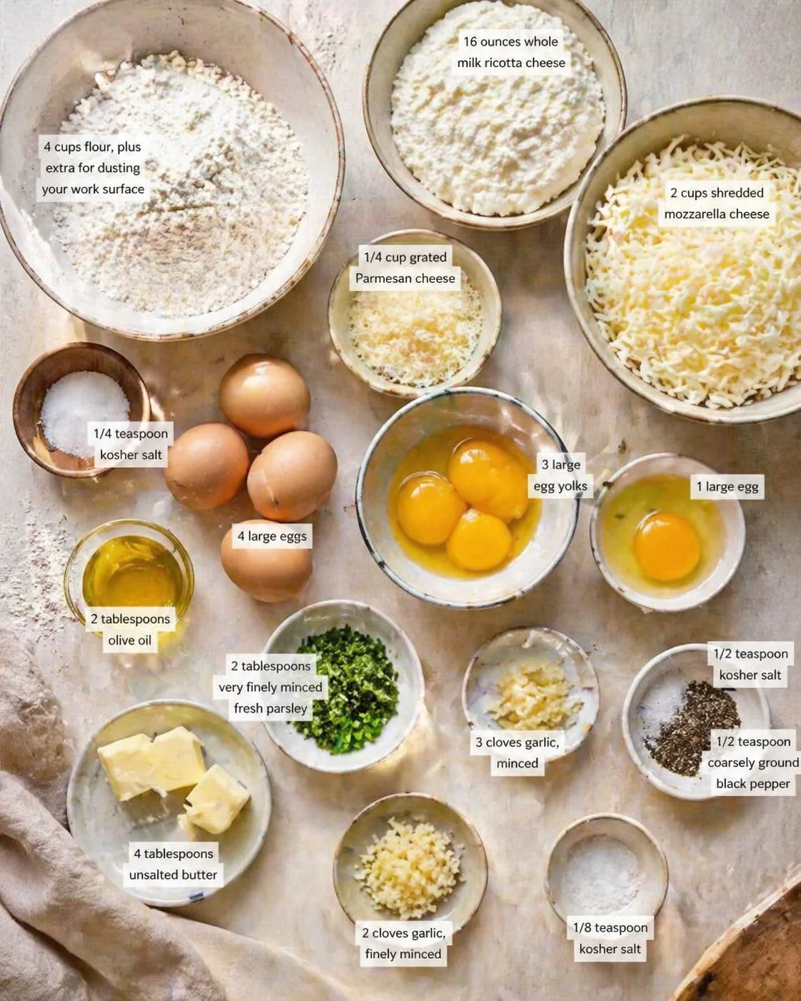 Measured ingredients arranged for Learn to make homemade cheese ravioli with this easy recipe!: 4 cups flour, plus extra for dusting your work surface, 1/4 teaspoon kosher salt, 4 large eggs, 3 large egg yolks, 2 tablesp
