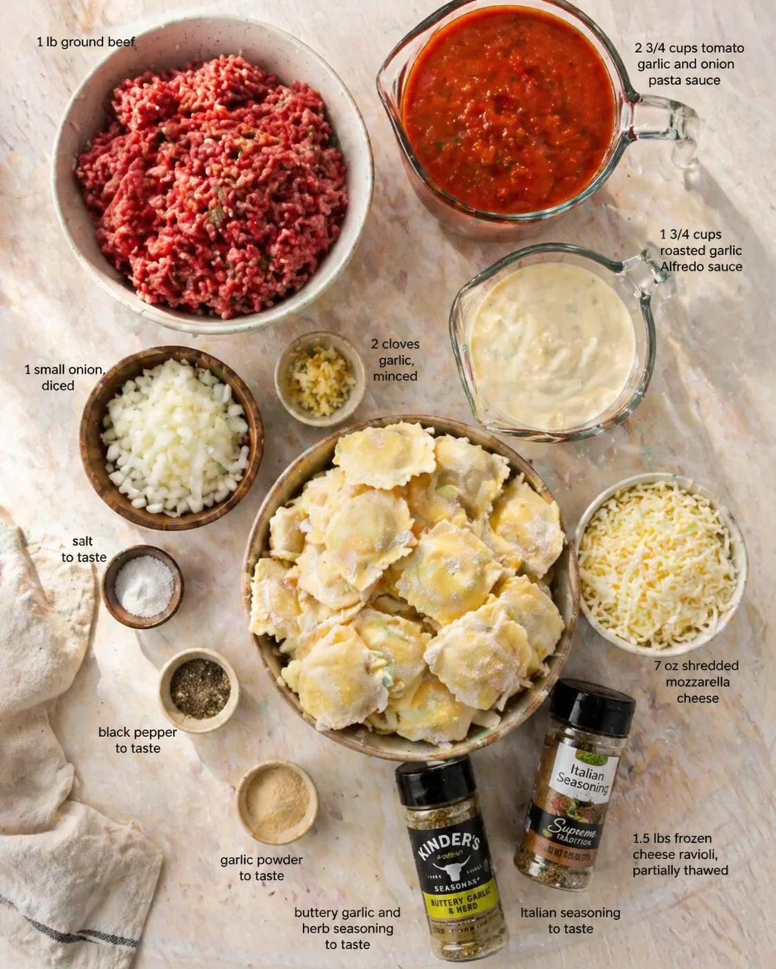 Measured ingredients arranged for Million Dollar Cheese Ravioli: 1 lb ground beef, 1 small onion, diced, 2 cloves garlic, minced, salt to taste, black pepper to taste, garlic powder to taste