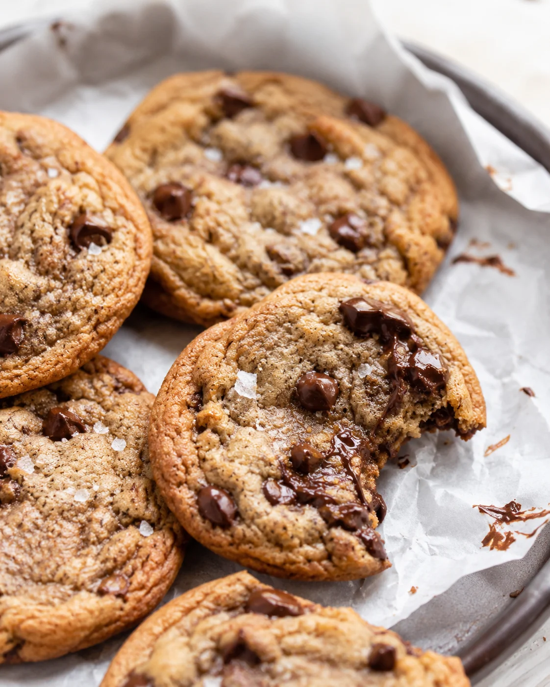Close-up of warm, chewy chocolate chip cookies on parchment paper