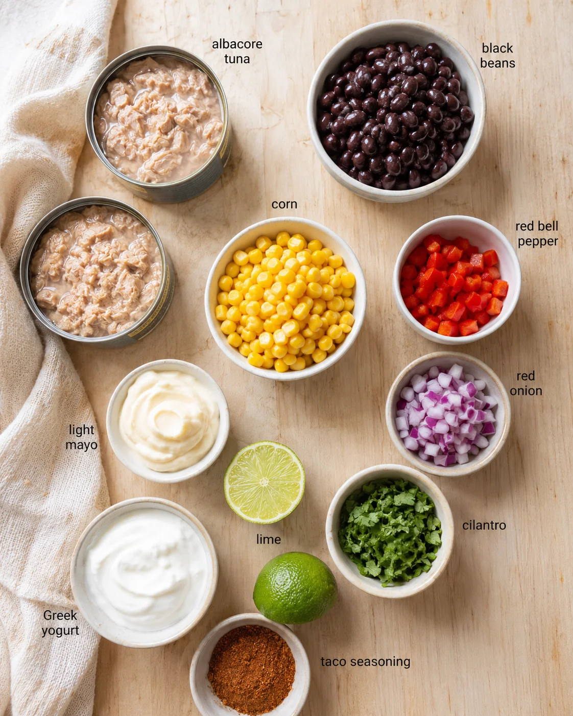 overhead view of assorted taco ingredients in bowls on a wooden board with labels