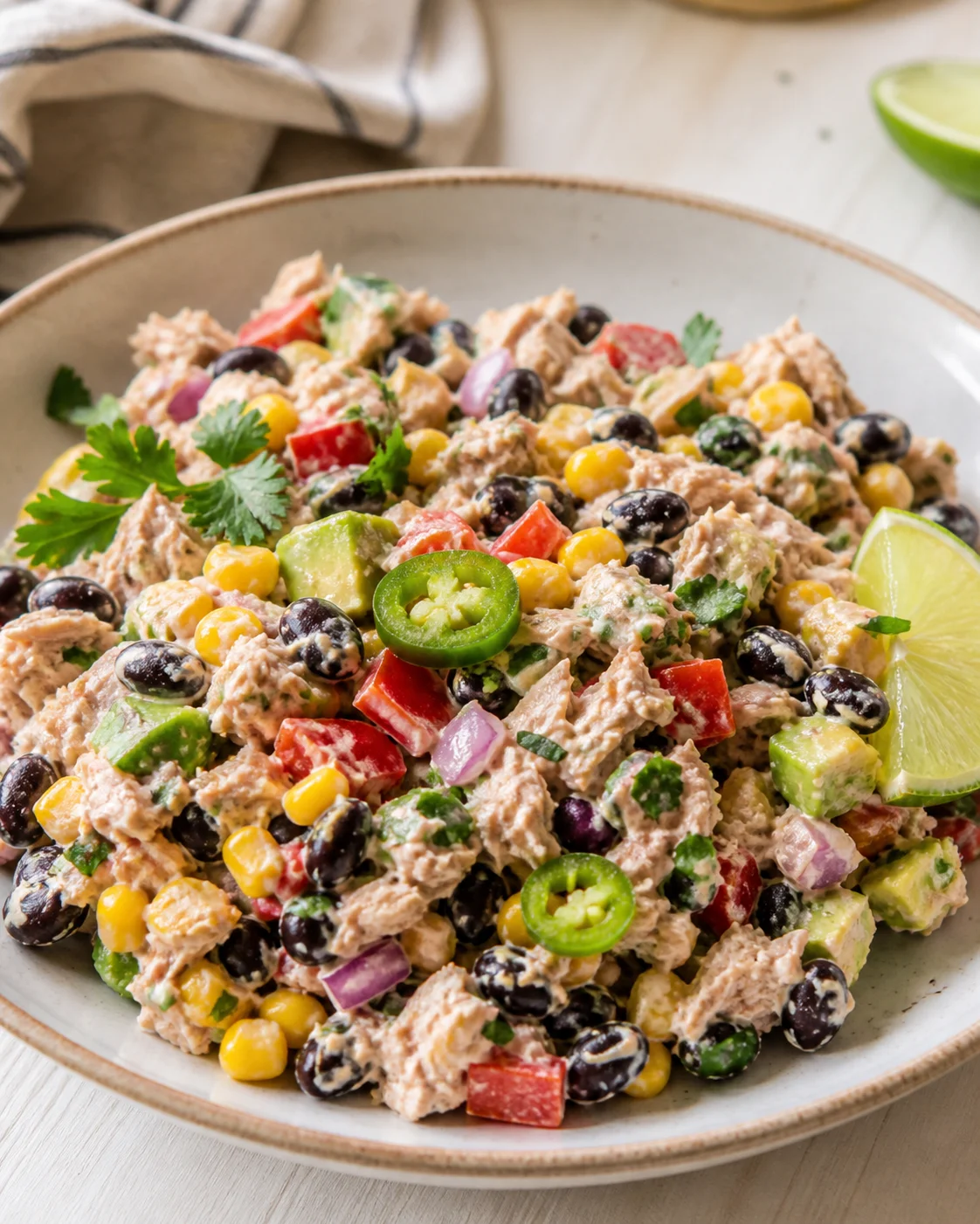 Single plated variation of Mexican Tuna Salad shown in a natural kitchen scene