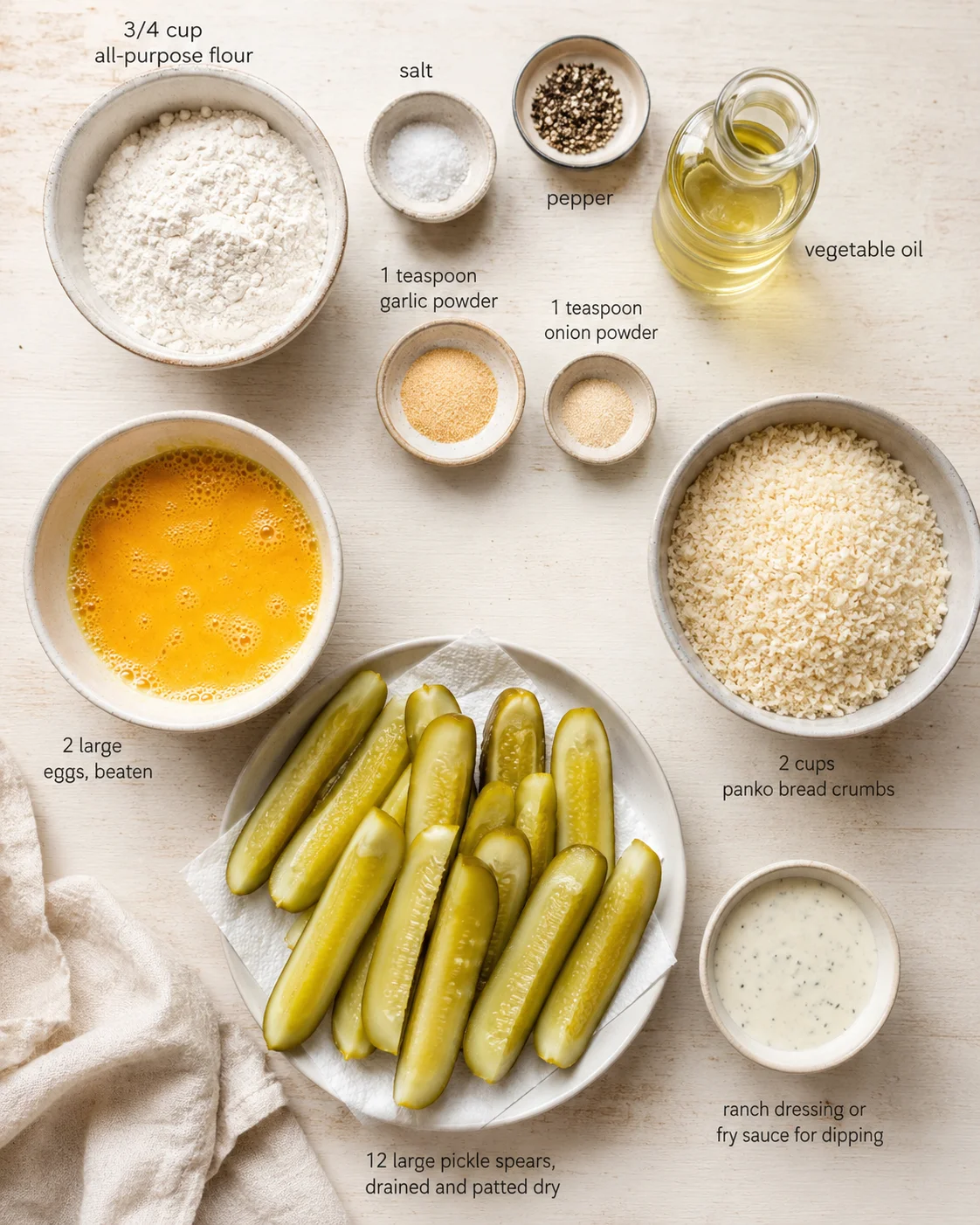 overhead view of pickles with flour, eggs, breadcrumbs, spices, oil, and sauce