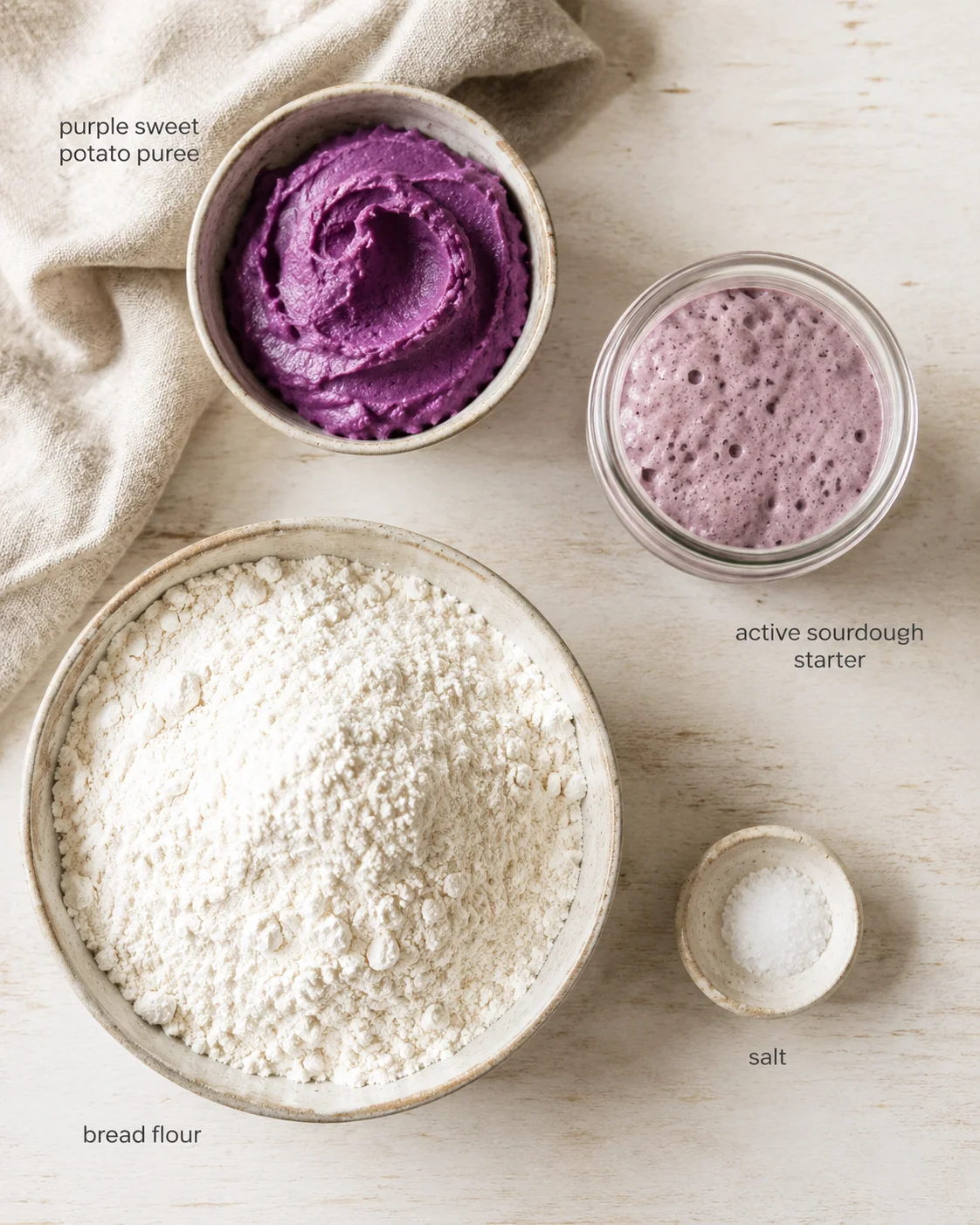Overhead view of baking ingredients: purple sweet potato puree, active sourdough starter, bread flour, and salt.