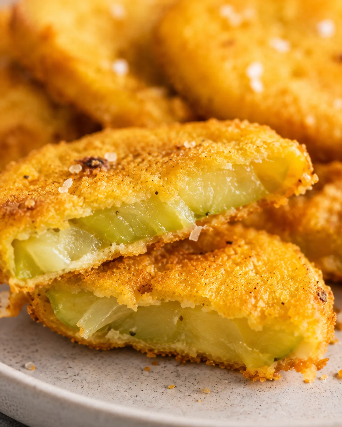 Golden crispy green tomatoes with crunchy coating and tangy interior.