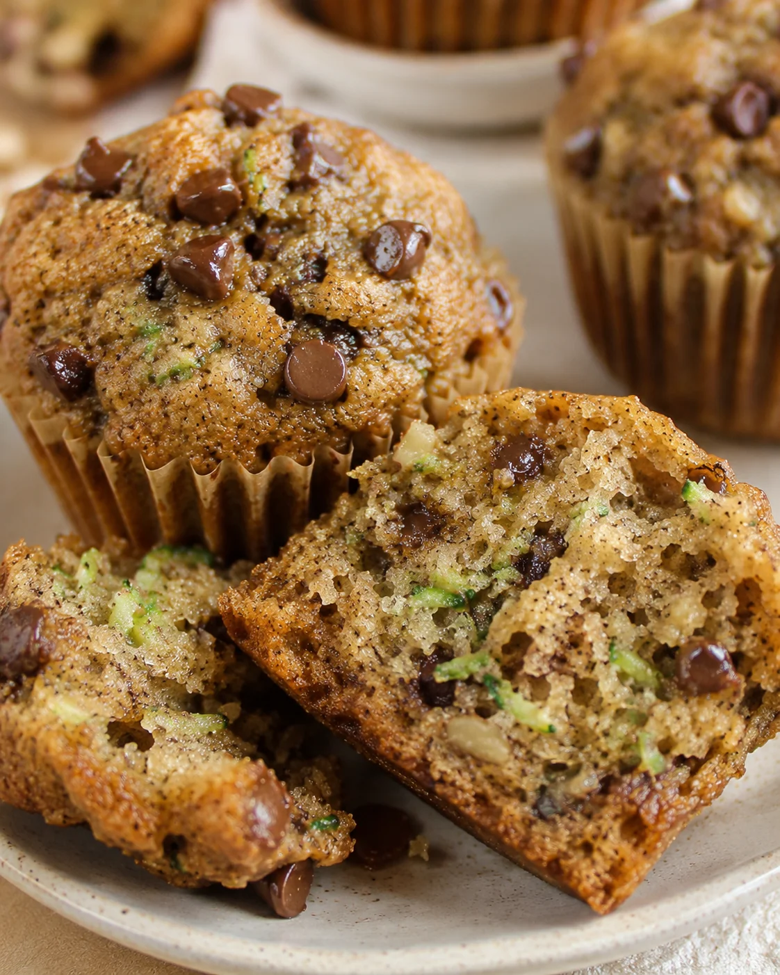 Close-up of freshly baked zucchini banana bread muffins with chocolate chips.