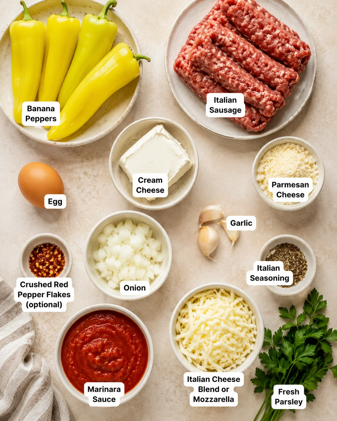 Ingredients for Italian sausage stuffed banana peppers, including yellow peppers, sausage, cheese, and herbs.