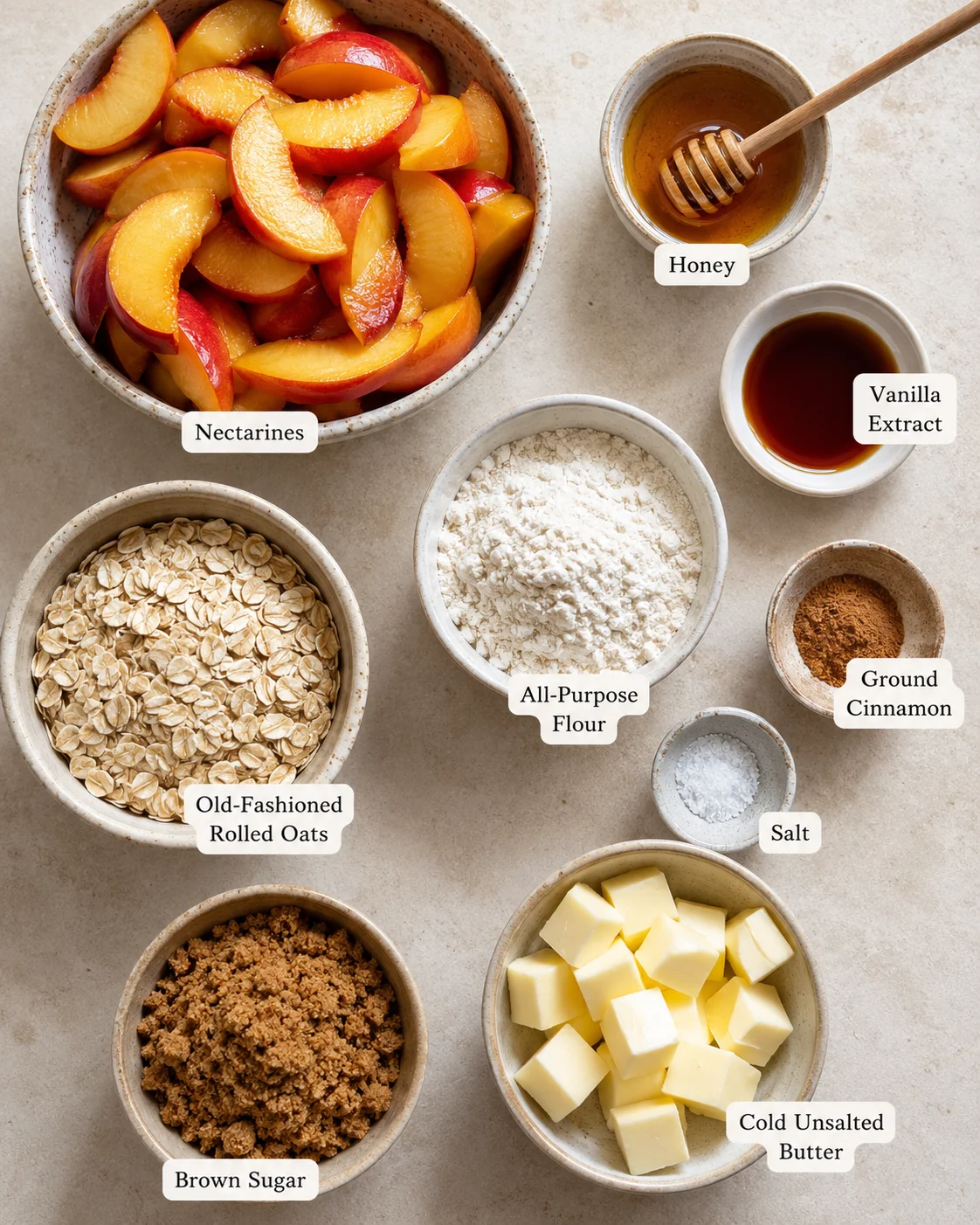 Assorted ingredients for nectarine crisp, including fresh nectarines, honey, and oats.