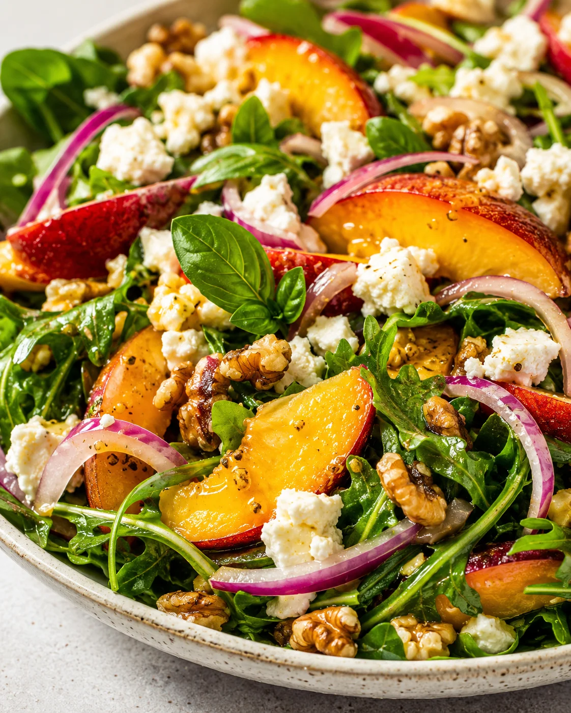 Summer Peach Salad with Goat Cheese Fresh peach salad with arugula, goat cheese, red onions, and walnuts.