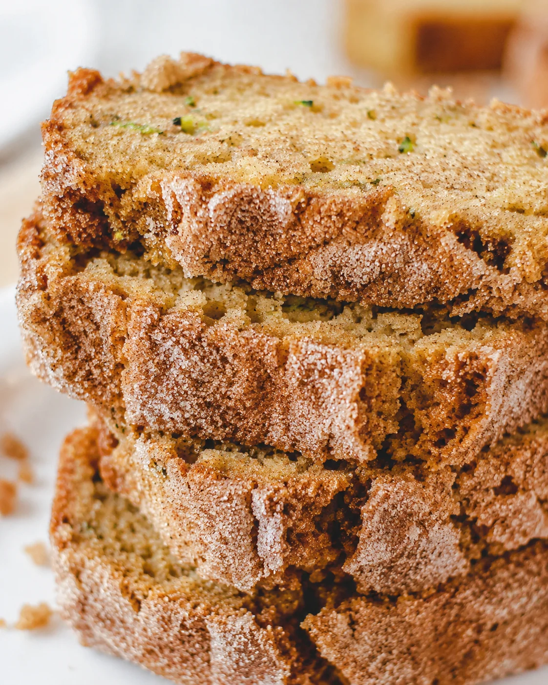 Close-up of sliced snickerdoodle zucchini bread with cinnamon sugar topping.