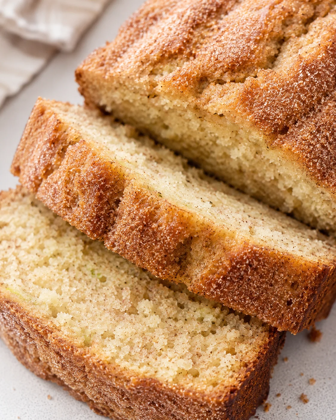 Close-up of sliced moist cinnamon zucchini bread with sugar topping