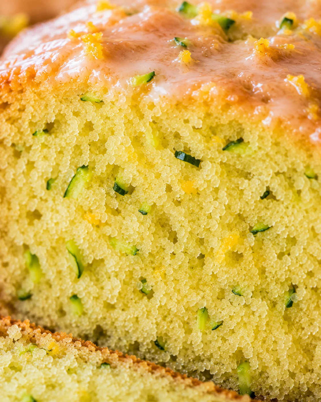 Close-up of moist lemon zucchini bread with a lemon glaze topping