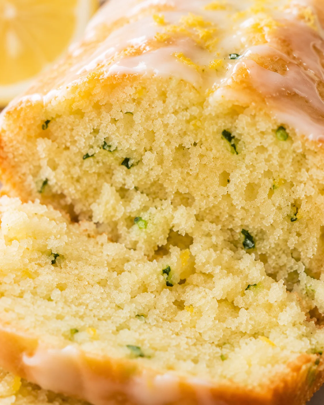 Close-up of moist lemon zucchini bread with a lemon glaze on top