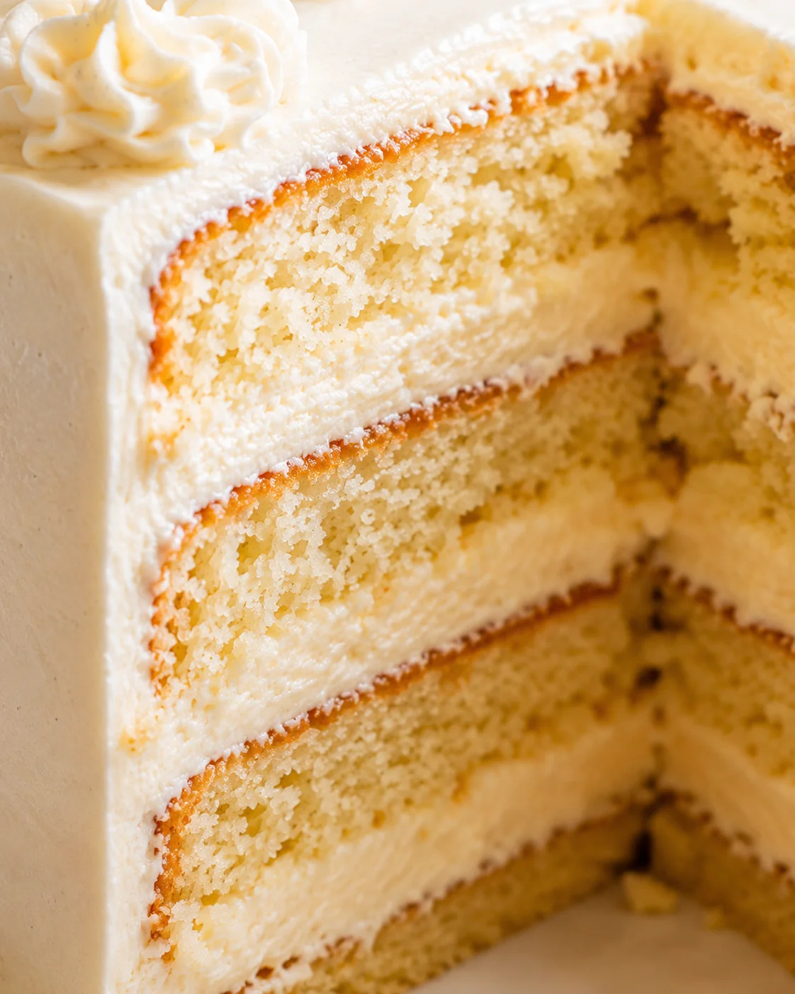 Delicious sliced French vanilla cake with fluffy layers and smooth frosting.