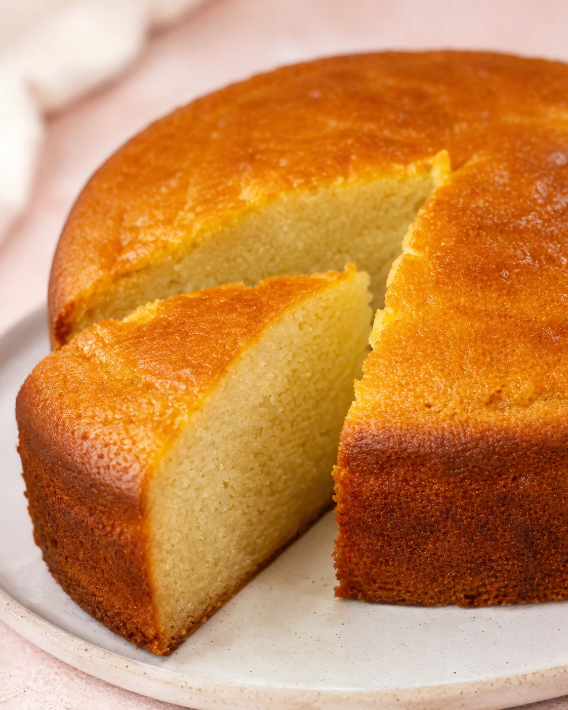 Delicious eggless vanilla and chocolate cakes on a white plate.