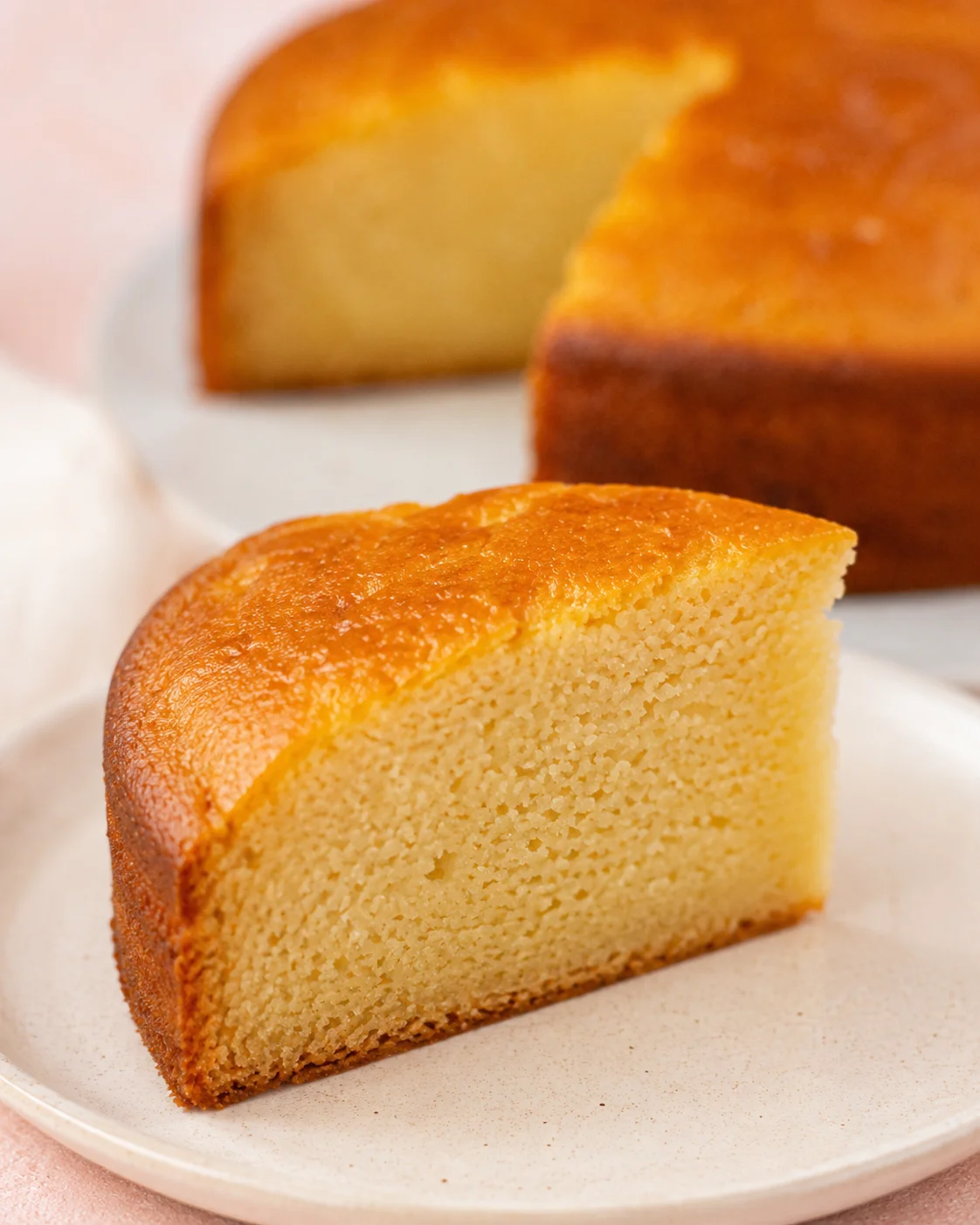 Close-up of moist, golden eggless vanilla and chocolate cakes on a white plate
