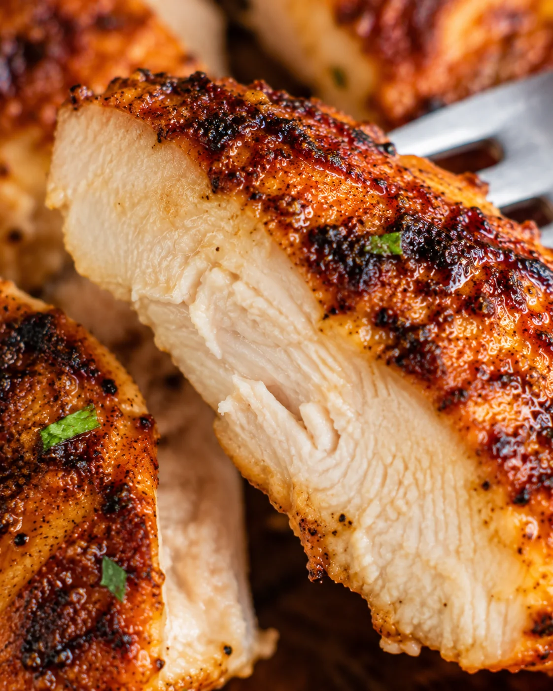Close-up detail of cooked interior and seared crust of chili lime chicken