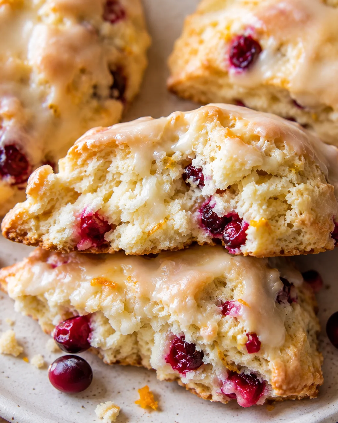 Interior of a broken cranberry orange scone showing tender crumb and cranberries