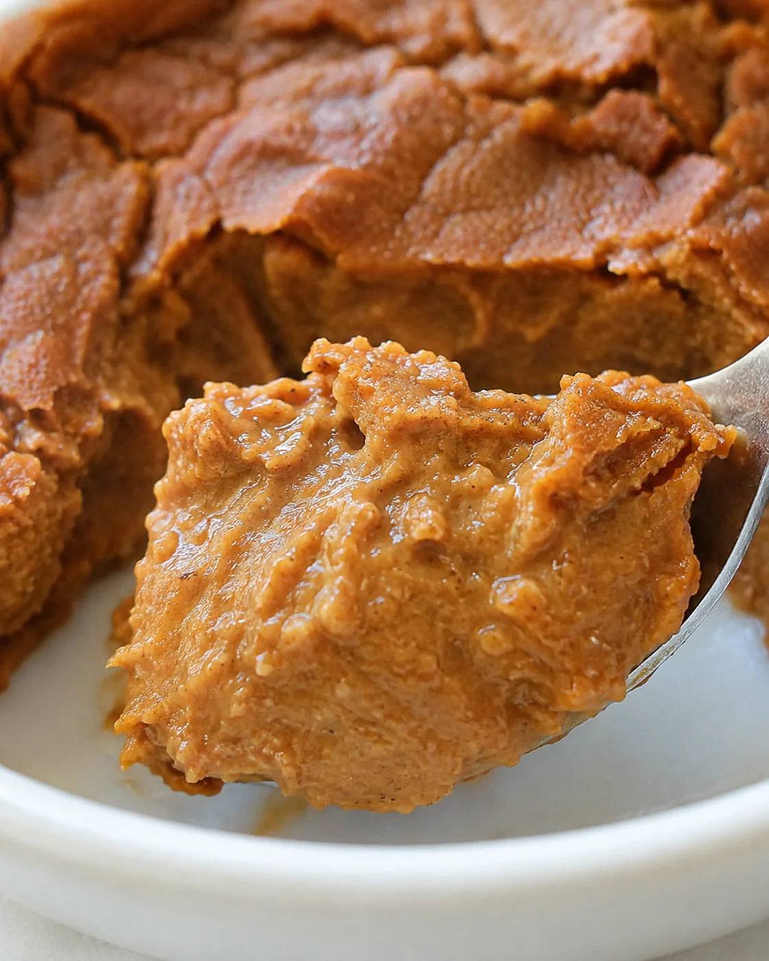 Close-up spoonful showing the creamy interior of crustless pumpkin pie