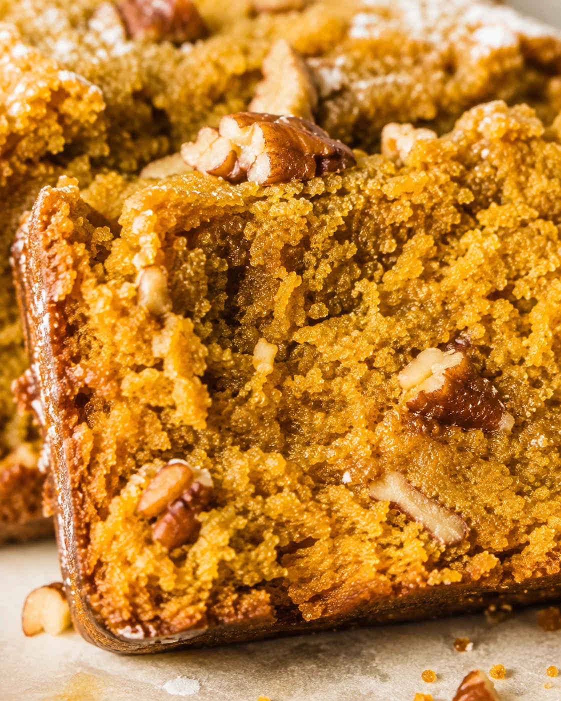 Macro view of the moist crumb and pecan pieces in keto pumpkin bread
