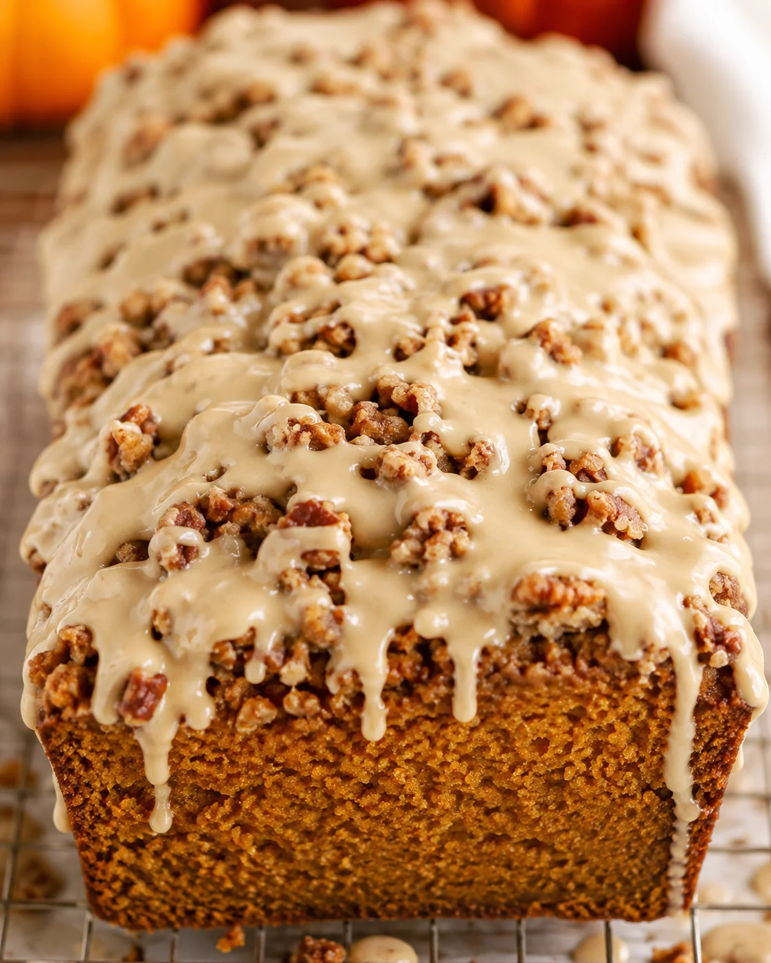 Maple pumpkin bread loaf with pecan streusel and maple glaze, close-up