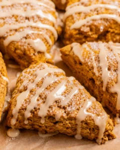 Close-up of maple pumpkin scones with maple glaze and coarse sugar