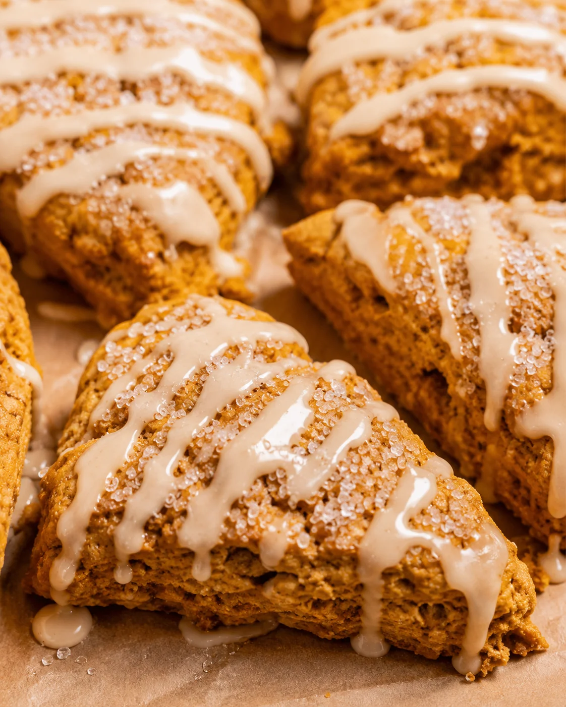 Close-up of maple pumpkin scones with maple glaze and coarse sugar