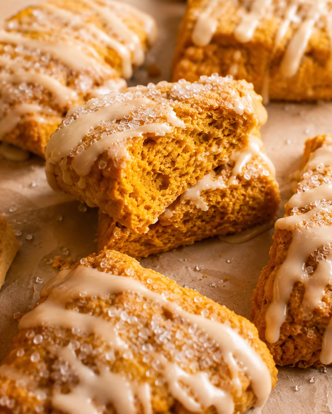 Sliced maple pumpkin scone stacked to show the moist interior and glaze