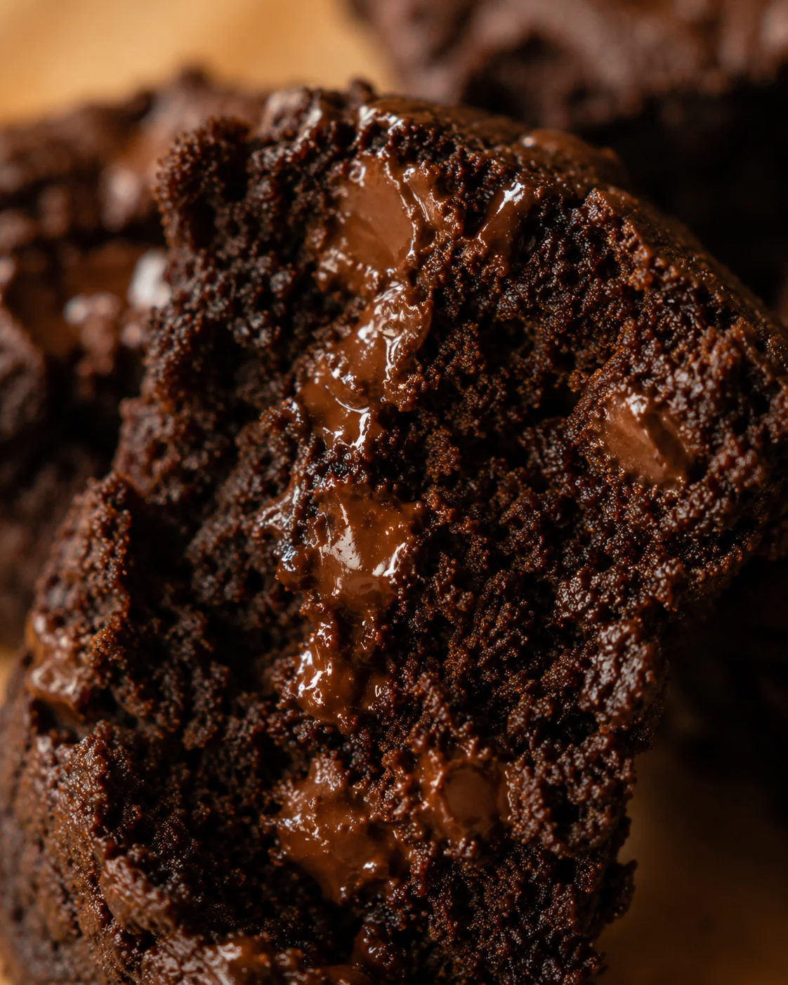 Close-up of a slice of moist chocolate pumpkin bread with gooey melted chocolate chips