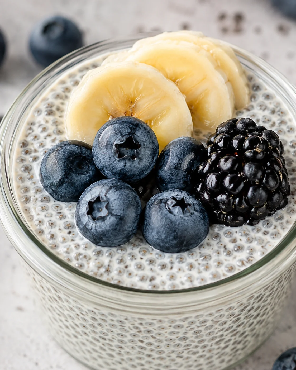 Vanilla Chia Pudding with Berries Creamy vanilla chia pudding topped with fresh blueberries and banana slices.