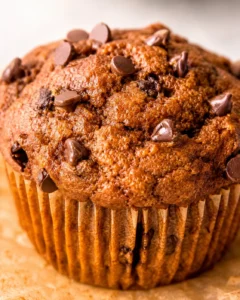 Close-up of a pumpkin protein muffin top studded with chocolate chips