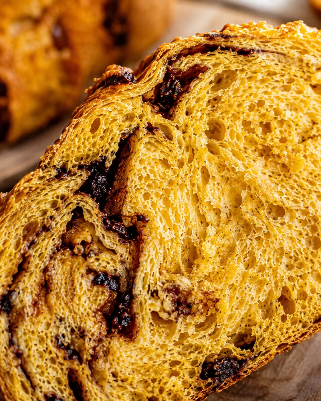 Detailed macro of pumpkin sourdough bread crumb and layered swirls