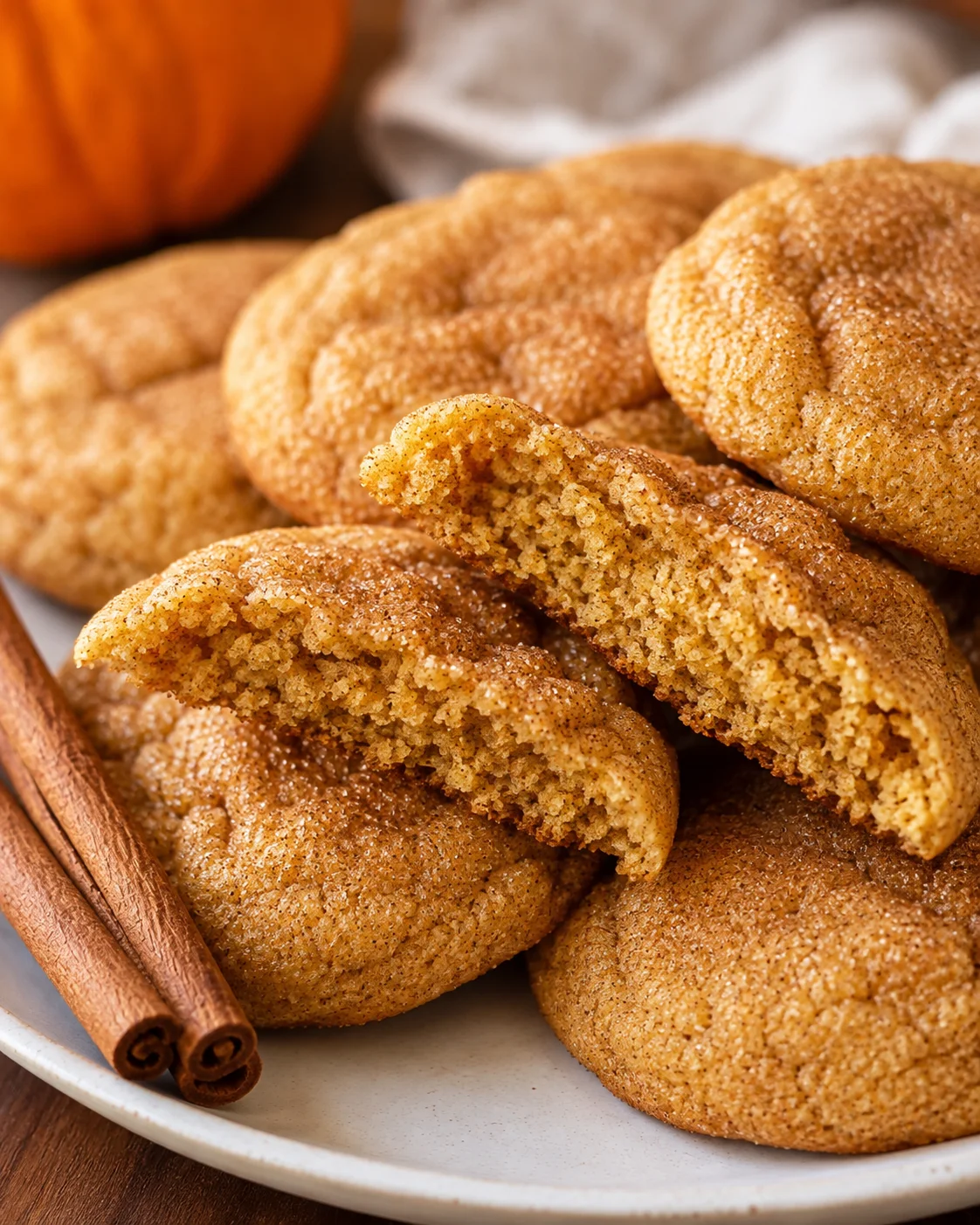 Stack of pumpkin spice cookies with one cookie broken to reveal the interior crumb